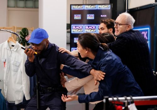 security-guard-using-walkie-talkie-handling-crowd-angry-aggressive-people-trying-break-into-shopping-mall-black-friday-crazy-anxious-shoppers-breaking-into-store-buy-things-sale_482257-67439